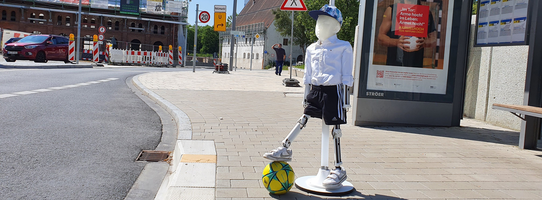 Source: THI Illustration of the child dummy with a ball on its foot by a street