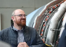An impressive teaching exhibit: Professor Ludwig König in front of the flight test engine in the G Building at THI (Photo: THI).