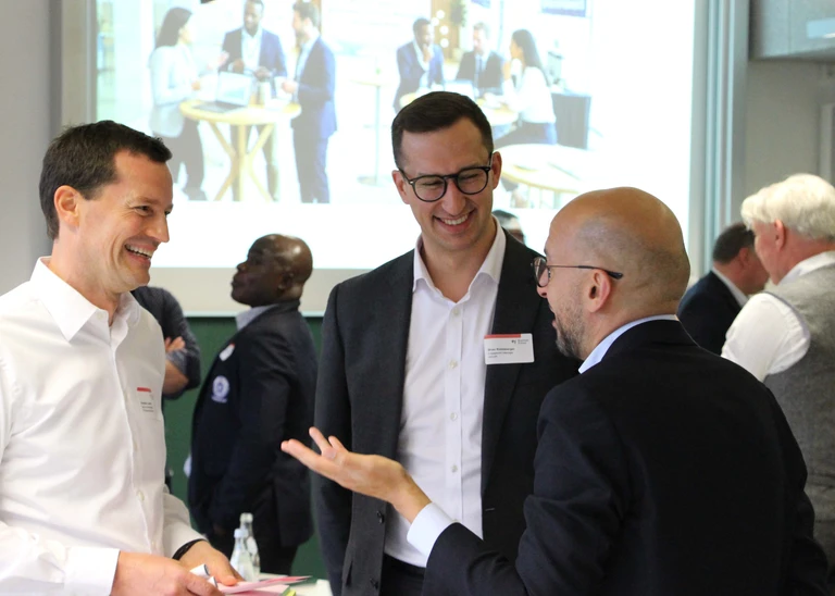 Three men are talking and laughing.